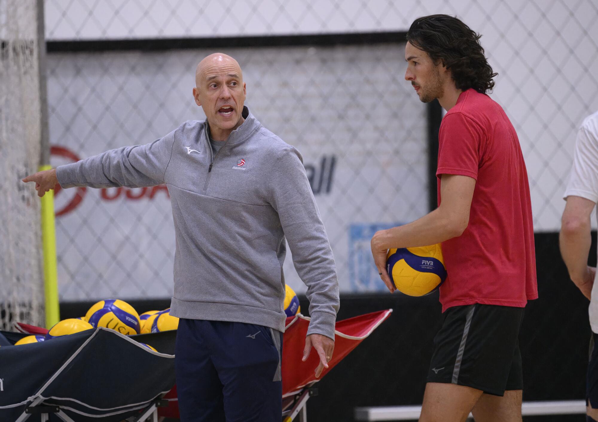 U.S. volleyball coach John Speraw, left, gives instructions during a national team practice session in Anaheim.