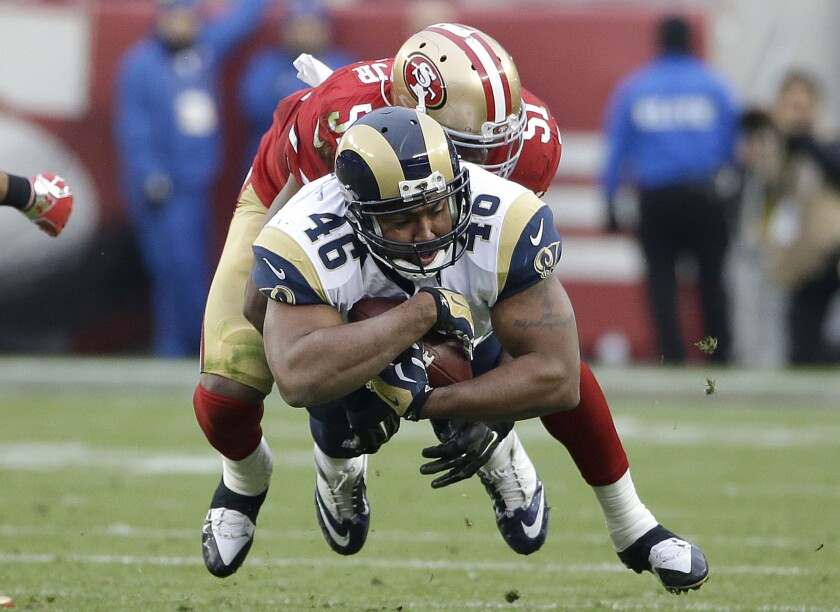Rams tight end Cory Harkey (46) is tackled by 49ers linebacker Gerald Hodges during a game on Jan. 3.