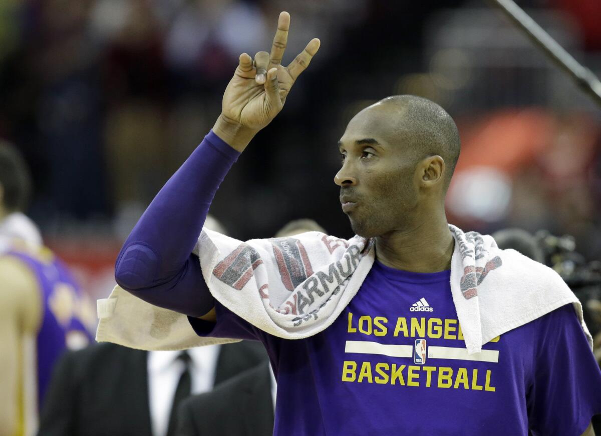 Kobe Bryant acknowledges the fans in Houston as he leaves the court after the Lakers' loss, 126-97, to the Rockets on Dec. 12.