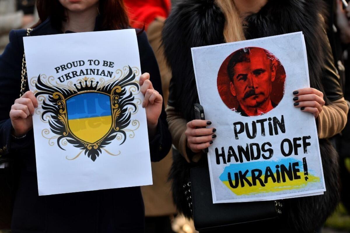 Protesters hold placards during a demonstration in London against Russia's involvement in the crisis in Ukraine.