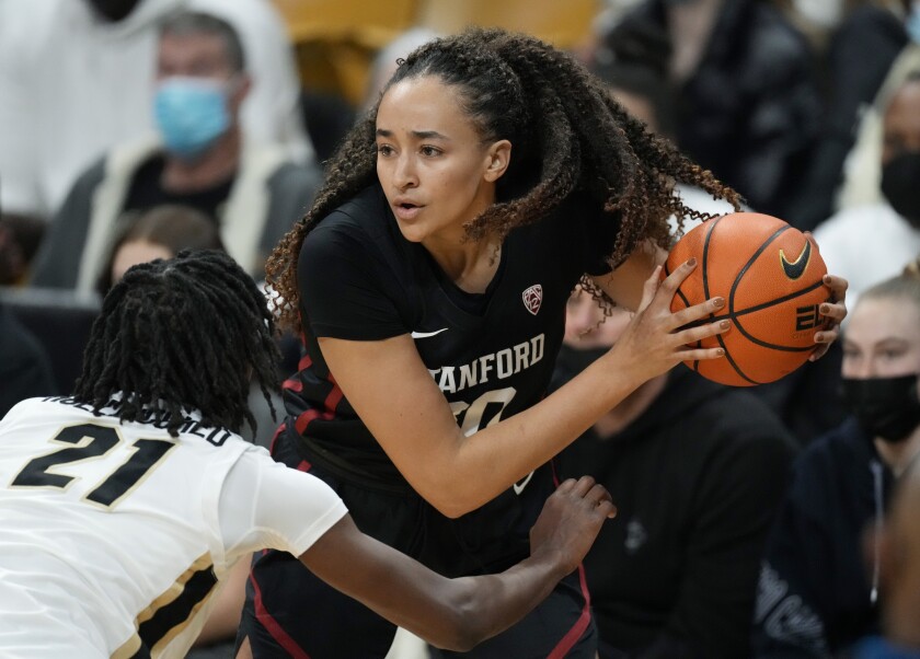 Stanford guard Haley Jones, right, looks to pass the ball as Colorado forward Mya Hollingshed defends in the first half of an NCAA college basketball game Friday, Jan. 14, 2022, in Boulder, Colo. (AP Photo/David Zalubowski)