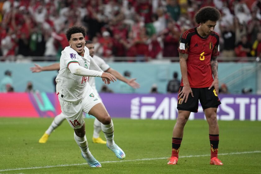 Morocco's Zakaria Aboukhlal celebrates his side's second goal besides Belgium's Axel Witsel during the World Cup group F soccer match between Belgium and Morocco, at the Al Thumama Stadium in Doha, Qatar, Sunday, Nov. 27, 2022. (AP Photo/Christophe Ena)