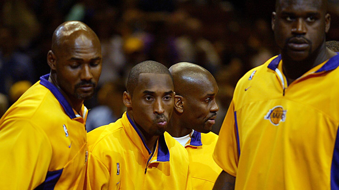 Lakers players (from left) Karl Malone, Kobe Bryant, Gary Payton and Shaquille O'Neal make their first game appearance together during a preseason game against the Clippers in Anaheim on Oct. 23, 2003.