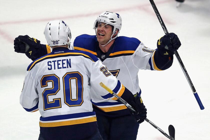 Blues left wing Jaden Schwartz (17) celebrates his game-winning goal against the Blackhawks with teammmate Alexander Steen (20) in Game 3.