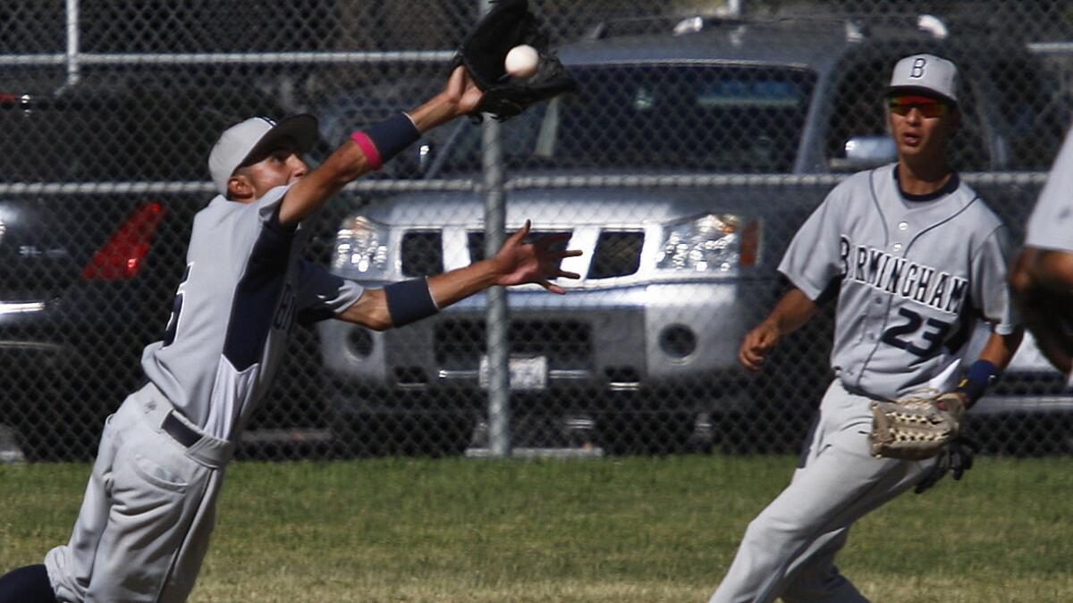 Birmingham's Alexis Miranda, left, makes a jumping catch of a line drive as teammate Victor Robles looks on during Friday's win over Granada Hills Kennedy. Birmingham will play Narbonne in the City Section Division I semifinals at USC on Tuesday.