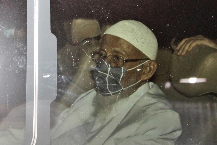 Islamic cleric Abu Bakar Bashir sits inside a van as he leaves upon his release from Gunung Sindur Prison in Bogor, West Java, Indonesia, Friday, Jan. 8, 2021. The convicted firebrand cleric who inspired the Bali bombers and other violent extremists walked free from prison Friday after completing his sentence for funding the training of Islamic militants. (AP Photo/Aditya Irawan)
