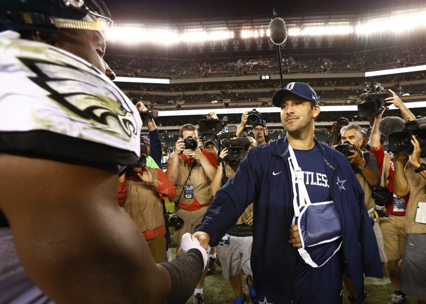 Dallas quarterback Tony Romo finished Sunday night's game against Philadelphia wearing street clothes and a sling.