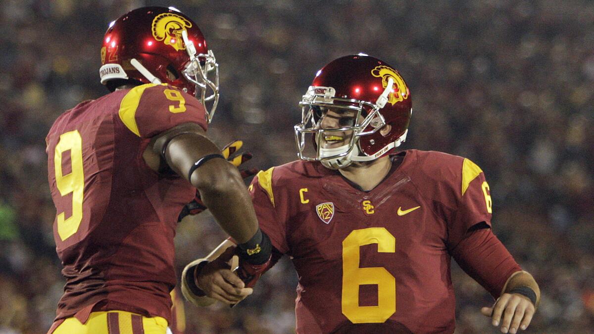 USC wide receiver JuJu Smith, left, and quarterback Cody Kessler celebrate a touchdown catch by teammate George Farmer (not pictured) during Thursday's win over California.