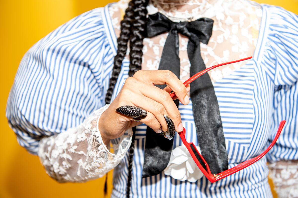 A close-up of Madame Gandhi's jewelry and sunglasses.