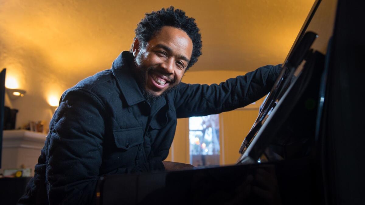 Producer and musician Terrace Martin sits at a piano at his home studio in L.A.