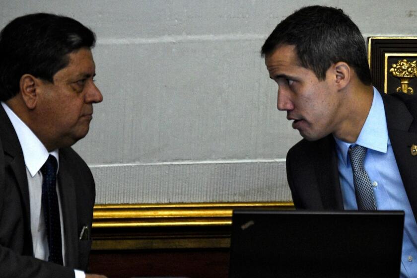 (FILES) In this file photo taken on March 06, 2019, Venezuelan opposition leader and self-proclaimed acting president Juan Guaido (R) speaks with Venezuelan National Assembly's first vice-president Edgar Zambrano during a session in Caracas. - Edgar Zambrano, a senior leader of the opposition-dominated National Assembly, was detained by Venezuelan intelligence agents on May 8, 2019, in the first arrest of a lawmaker since the failed uprising against President Nicolas Maduro last week. (Photo by Federico Parra / AFP)FEDERICO PARRA/AFP/Getty Images ** OUTS - ELSENT, FPG, CM - OUTS * NM, PH, VA if sourced by CT, LA or MoD **