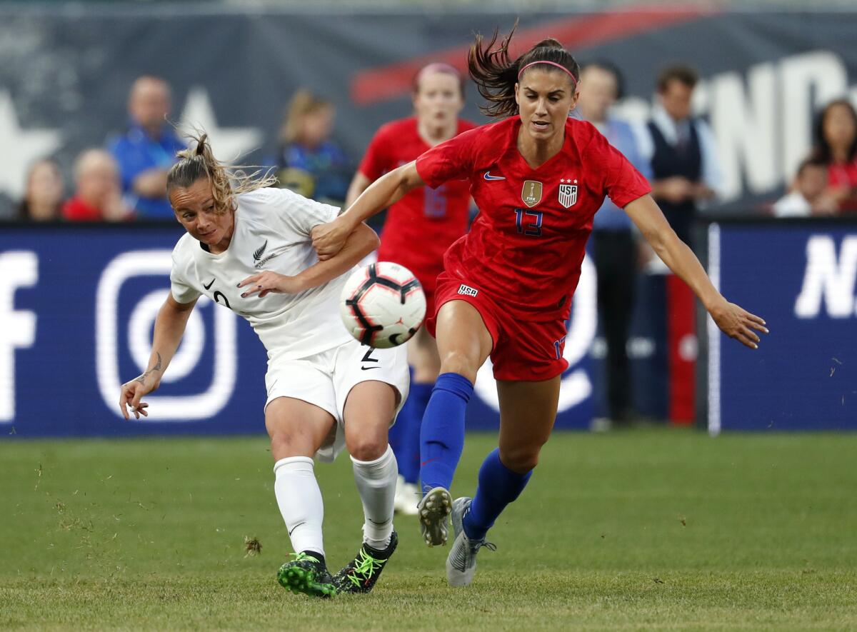 Alex Morgan and New Zealand's Ria Percival chase after a loose ball during an international friendly May 16 in St. Louis.