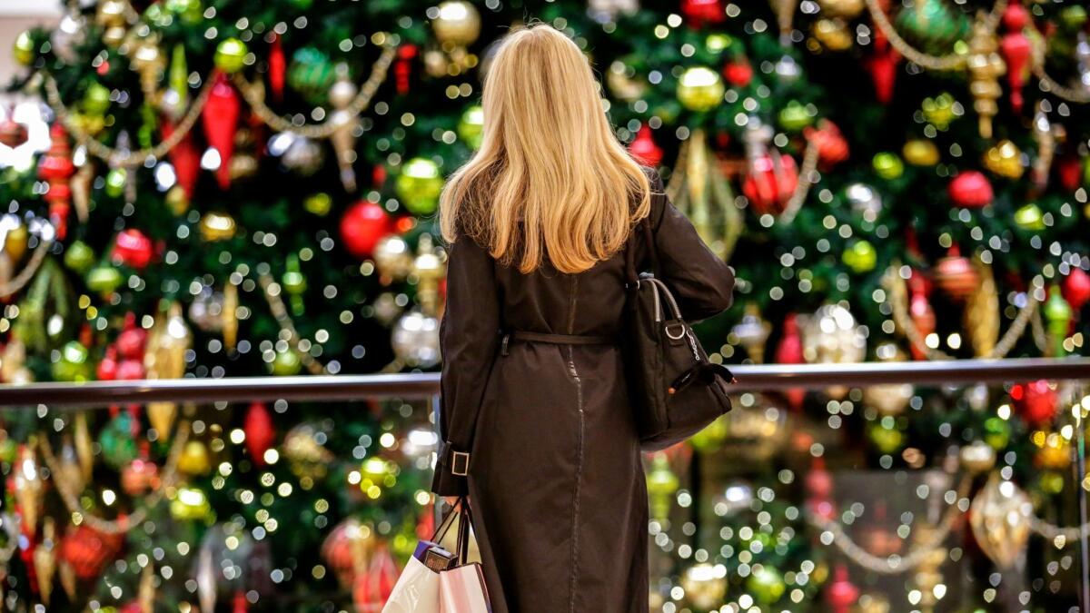 A shopper admires a Christmas tree at South Coast Plaza last year.
