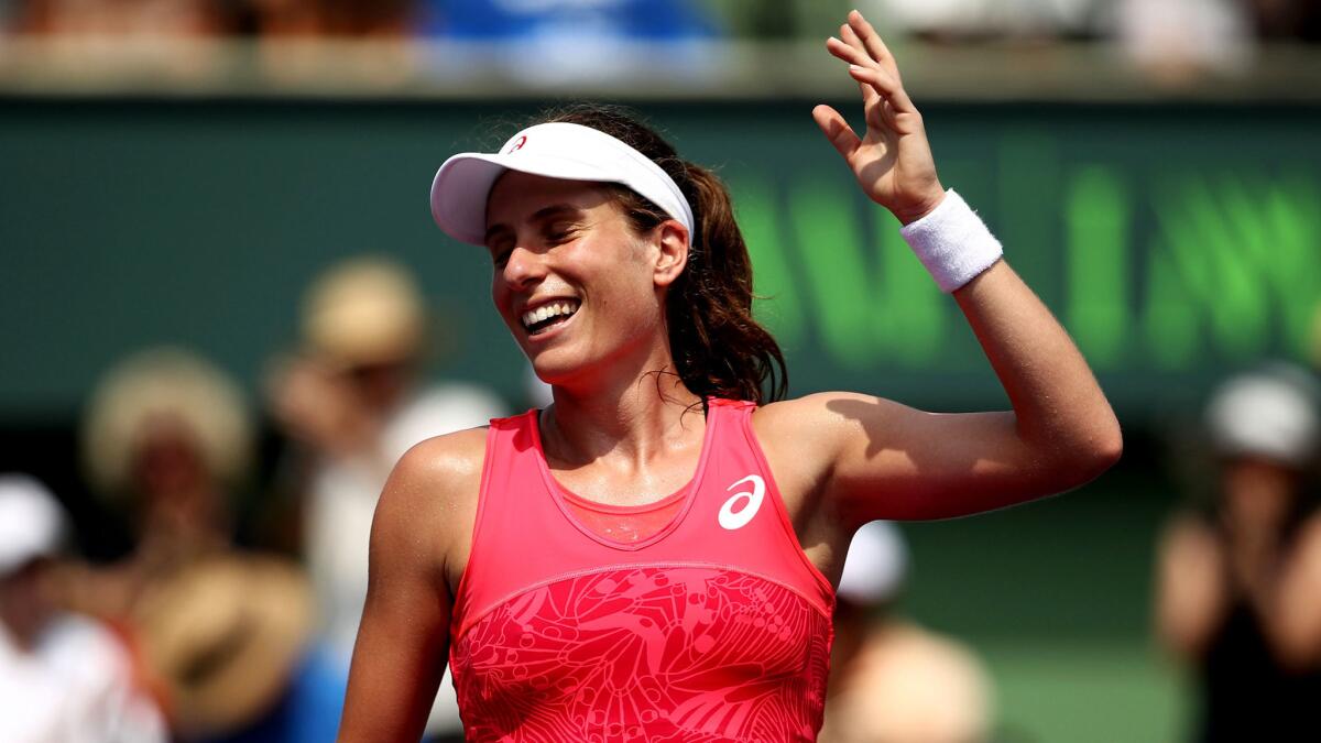 Johanna Konta acknowledges the fans after winning match point against Caroline Wozniacki in the championship match of the Miami Open on Saturday.