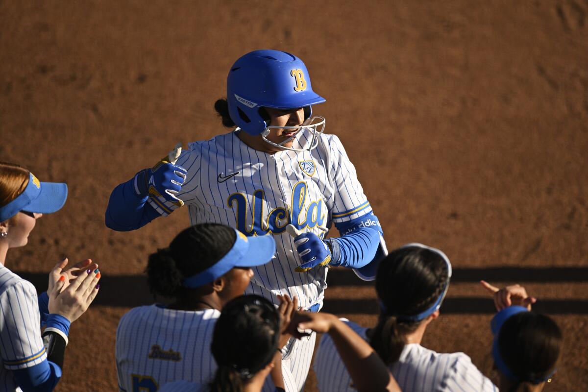 UCLA's Sharlize Palacios celebrates with teammates after hitting a home run against Stanford on April 20.