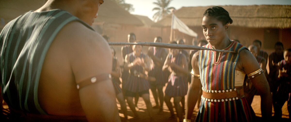 Two warriors face each other in a scene from "The Woman King."