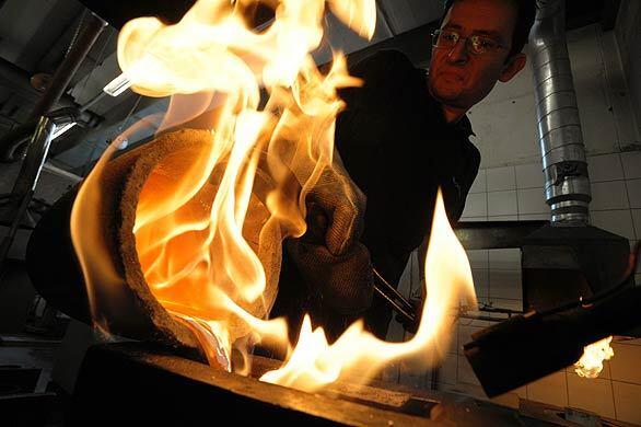 An Austrian worker pours melted silver into a form at the private Oegussa factory in Vienna today. The gold bullion maker announced Monday that it has increased its production tenfold, as the global financial crisis pushes investors toward a precious metal seen as a haven during economic turmoil. Demand is particularly high for gold bars of 50 grams to one kilogram since gold is tax-free for transactions of less than 15,000 euros ($20,000), Oegussa said.