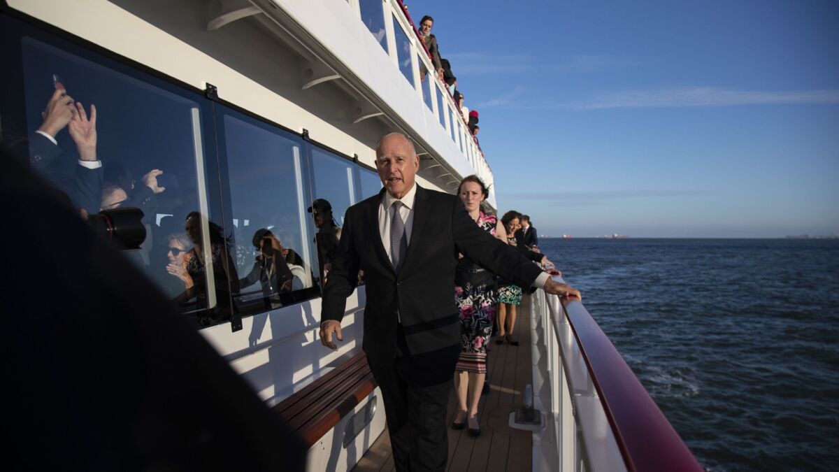 Gov. Jerry Brown makes his way to the bow of a hybrid ferry cruising the San Francisco Bay at the end of the day's events during the Global Climate Action Summit on Thursday.