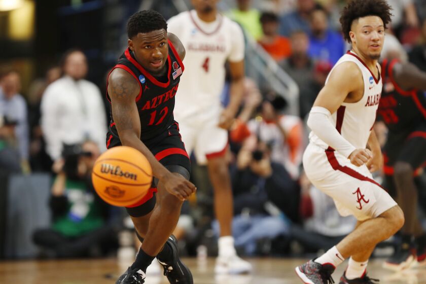 Louisville, KY - March 24: San Diego State's Darrion Trammell steals the ball and then scored from Alabama's Mark Sears in a Sweet 16 game in the NCAA Tournament on Friday, March 24, 2023 in in Louisville, KY. (K.C. Alfred / The San Diego Union-Tribune)