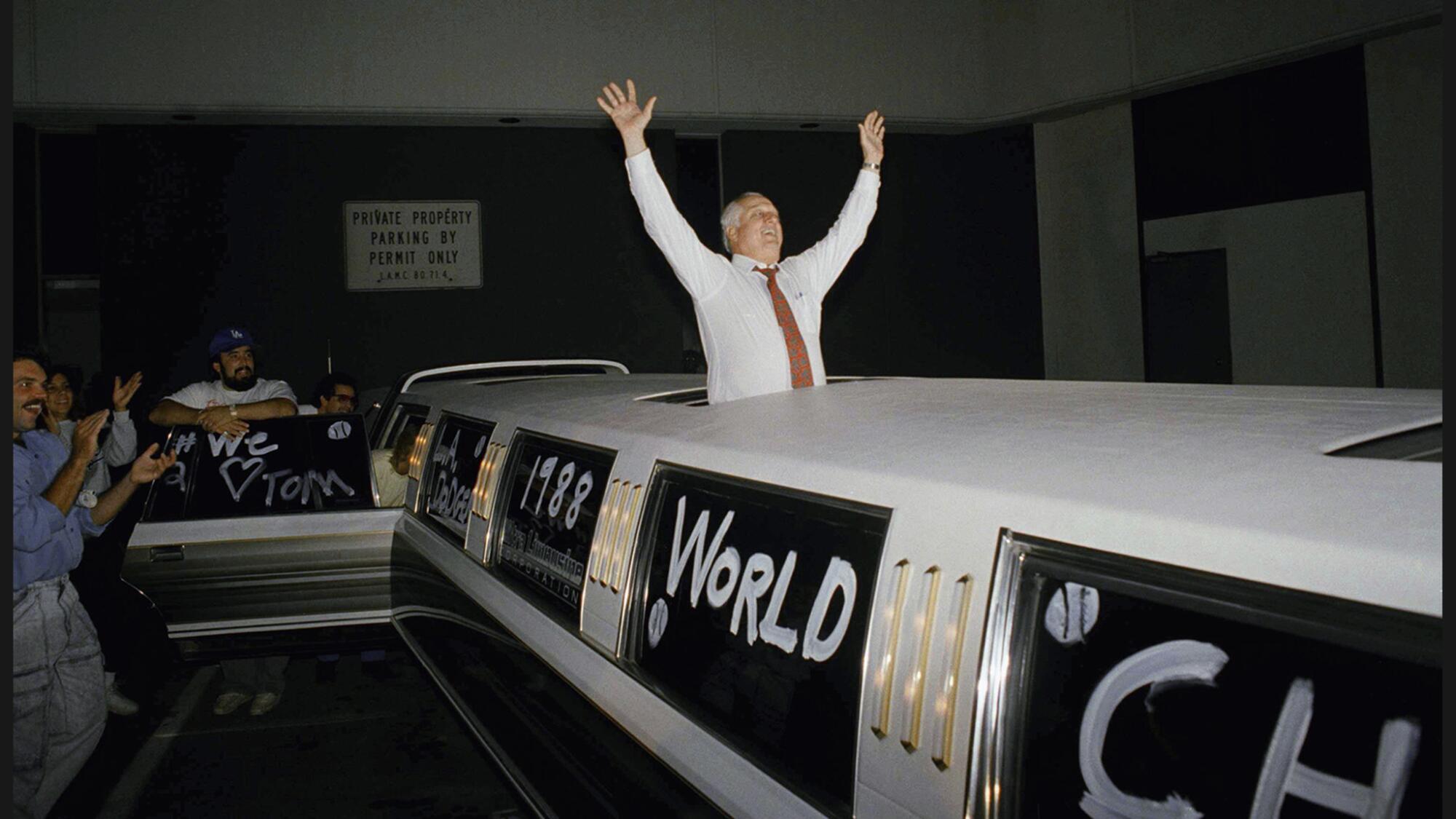 Tommy Lasorda celebrates the Dodgers' 1988 World Series victory from a stretch limousine in Los Angeles. 