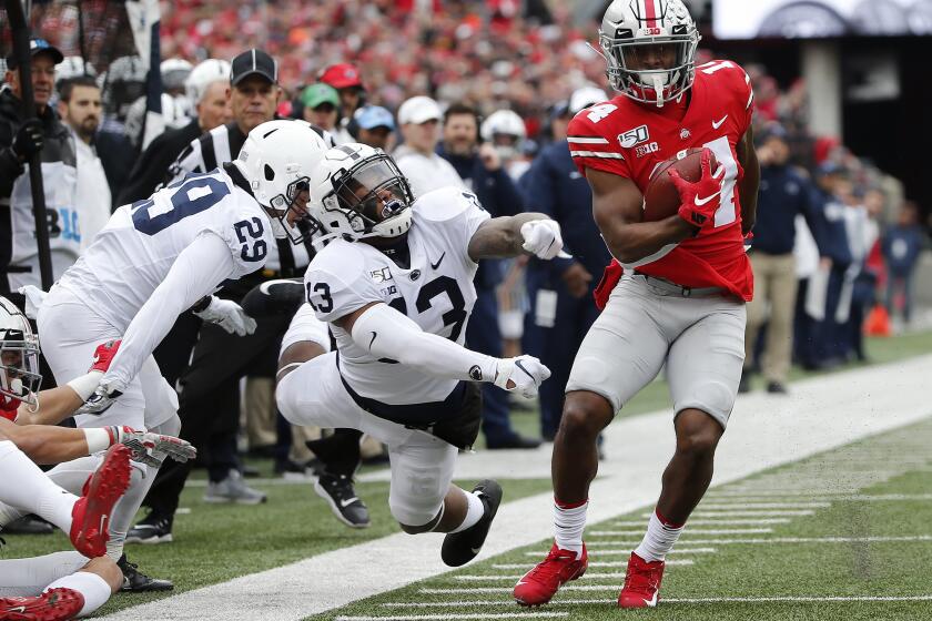 Ohio State Buckeyes wide receiver K.J. Hill Jr. (14) makes a catch past Penn State Nittany Lions linebacker Ellis Brooks (13) during the first quarter of the NCAA football game at Ohio Stadium in Columbus on Saturday, Nov. 23, 2019. (Adam Cairns/Columbus Dispatch/TNS) ** OUTS - ELSENT, FPG, TCN - OUTS **
