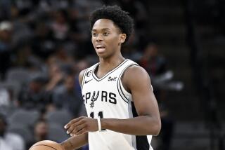 San Antonio Spurs' Josh Primo brings the ball up-court during the second half of a preseason NBA basketball game against the Oklahoma City Thunder, Thursday, Oct. 13, 2022, in San Antonio. Oklahoma City won 118-112. (AP Photo/Darren Abate)