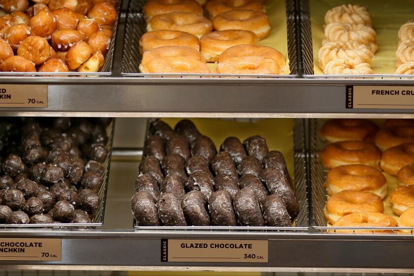 This Thursday, July 28, 2016, photo shows donuts for sale at a Dunkin' Donuts in Edmond, Okla. Dunkin' Brands Group, Inc. reports financial earnings Thursday, Feb. 9, 2017. (AP Photo/Sue Ogrocki)