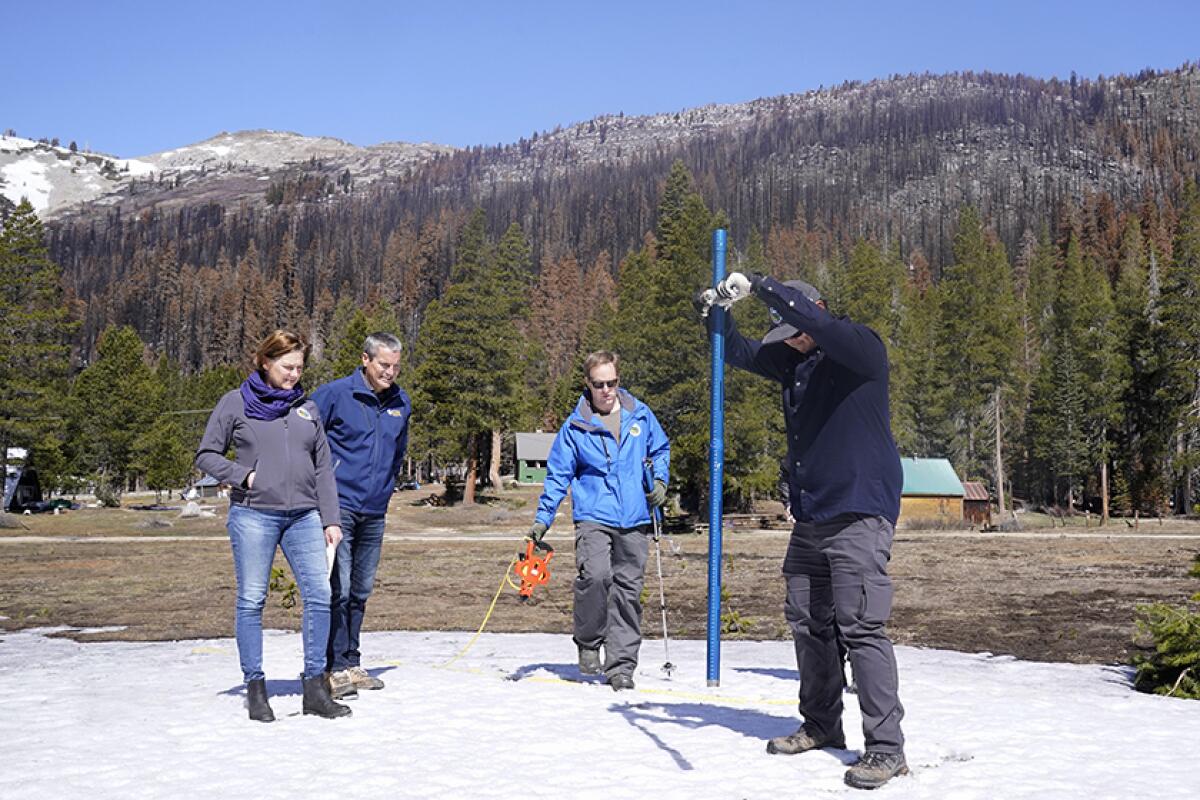 State water resources officials measure the Sierra snowpack near Lake Tahoe on April 1.