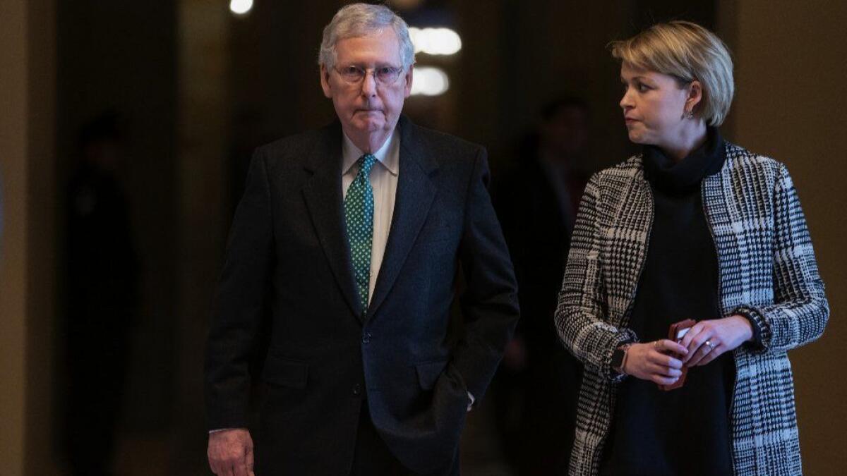 Senate Majority Leader Mitch McConnell, R-Ky., joined at right by aide Stefanie Hagar Muchow.
