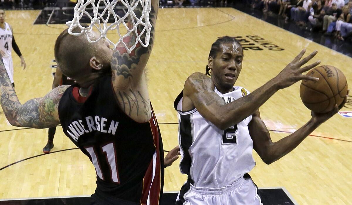 Spurs forward Kawhi Leonard drives for a layup against Heat center Chris Andersen in the first half of Game 5 on Sunday in San Antonio.