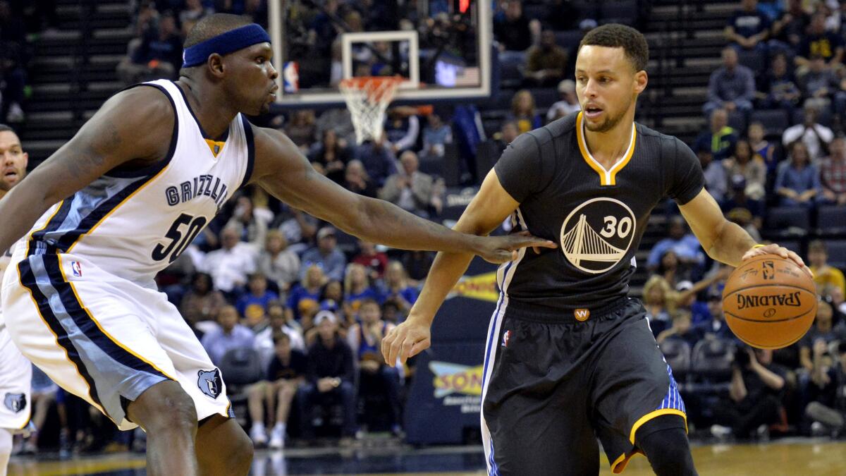 Grizzlies forward Zach Randolph pressures Warriors guard Stephen Curry (30) during the first half Saturday.