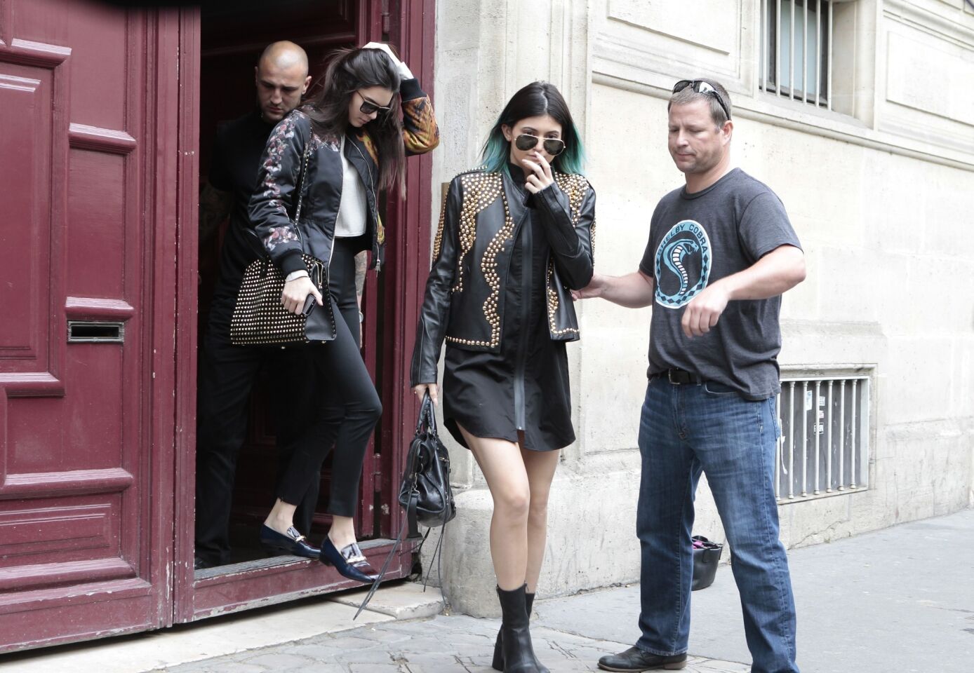 Kylie Jenner, left, and Kendall Jenner leave Kanye West's Paris apartment on May 20.