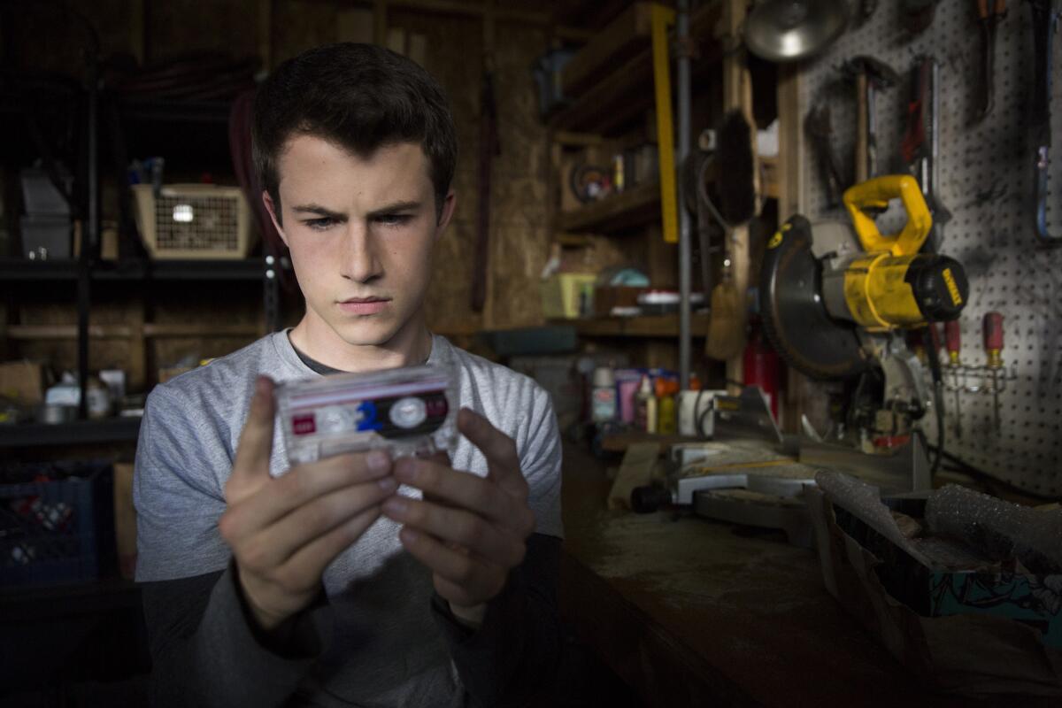 Dylan Minnette (playing Clay Jensen) listen to the tapes of deceased character Hannah Baker on "13 Reasons Why." (Netflix / Beth Dubber)