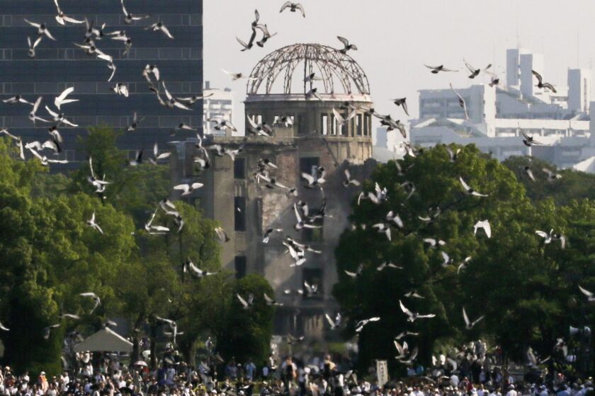 At Hiroshima Peace Memorial Park in Japan, doves fly over the atomic bomb dome during a 2015 ceremony marking the 70th anniversary of the atomic bombing.