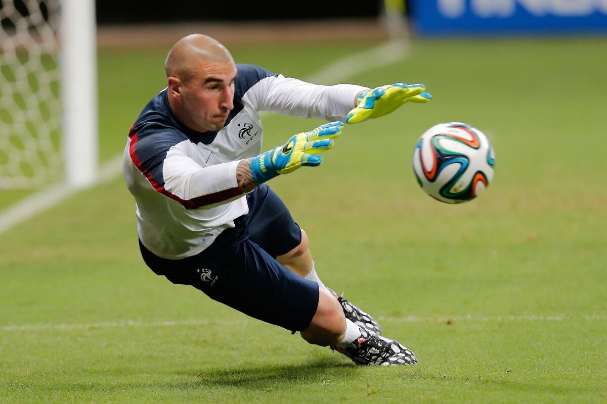 France goalkeeper Stephane Ruffier makes a stop during practice ahead of his team's match with Switzerland.