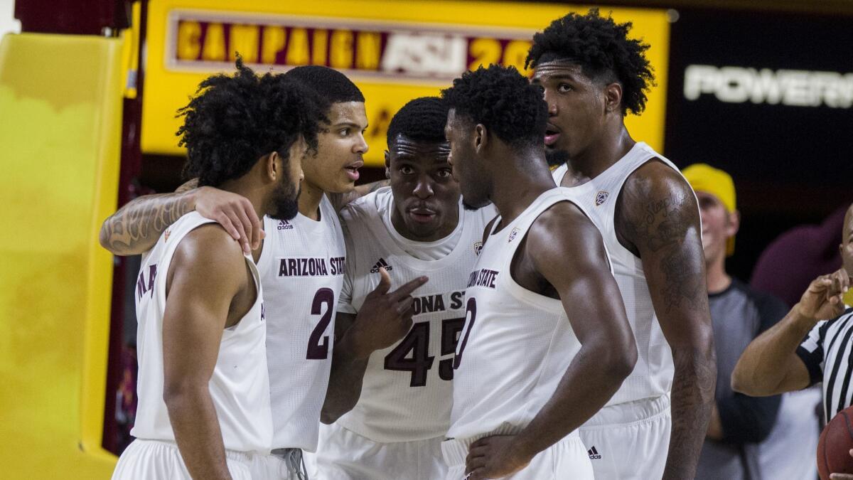 Arizona State's Remy Martin, left, Rob Edwards (2), Zylan Cheatham (45), Romello White, right, and Luguentz Dort (0) huddle during the second half of a game against Washington on Feb. 9.