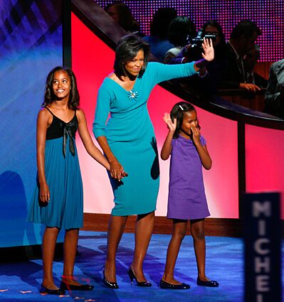 Michelle Obama, shown with her and Barack Obama's two daughters, waves to the crowd in Denver after her convention address.