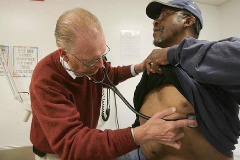 Dennis Bleakley examines Edward Sankey, 55, at the JWCH Medical Clinic in Los Angeles. Sankey lives in a hotel.