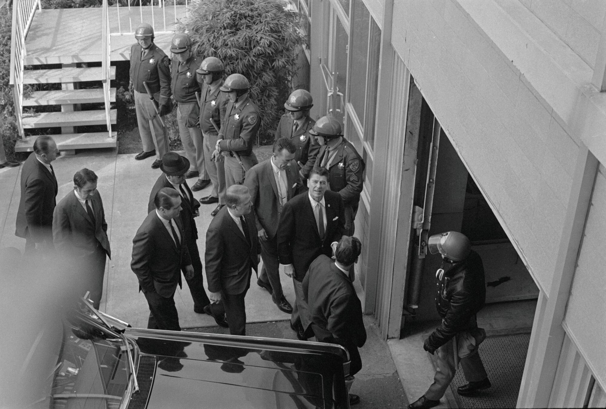 Gov. Ronald Reagan walks past some of the 100 law enforcement officers assembled at University Hall at UC Berkeley.