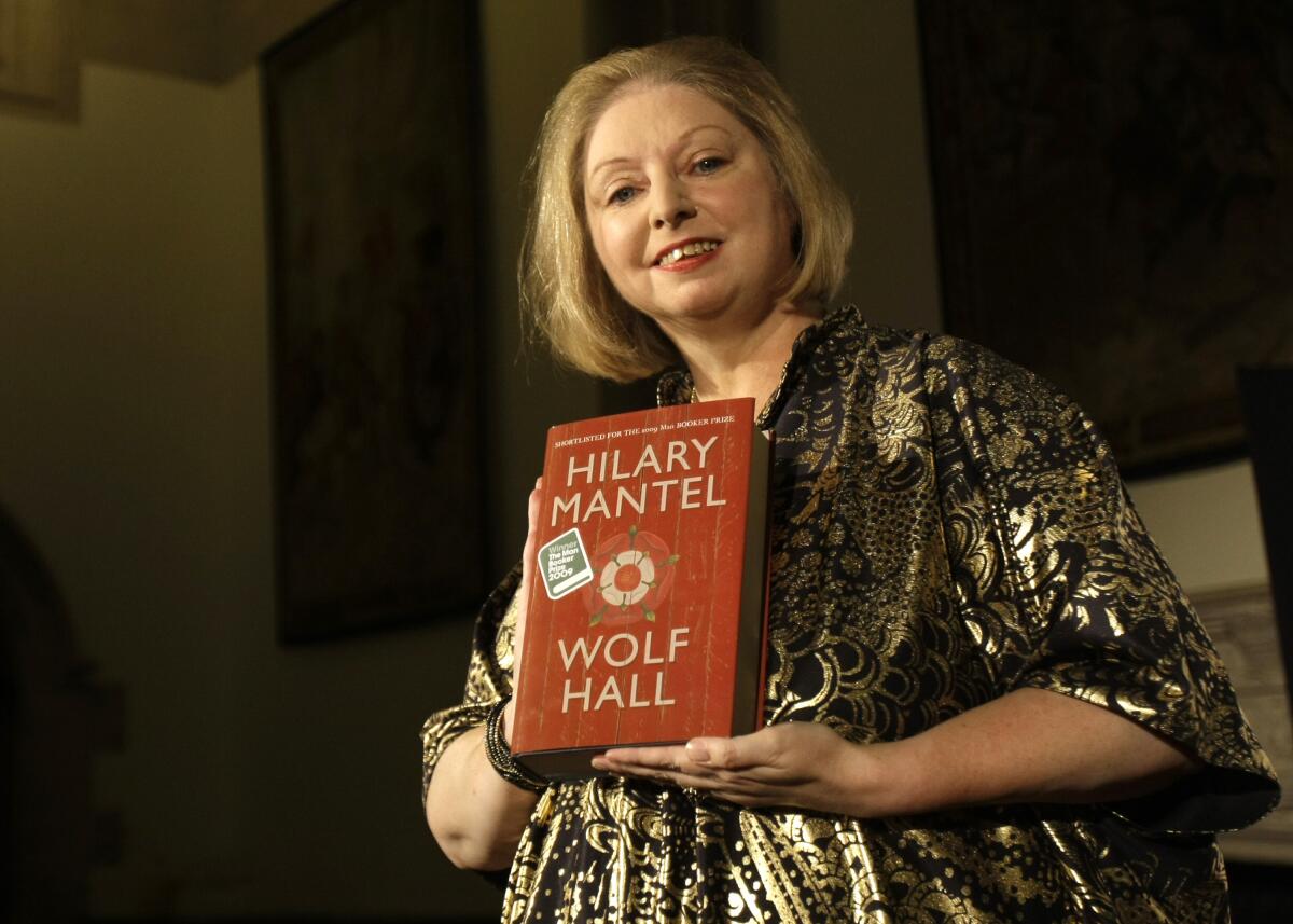 Hilary Mantel holds a copy of her book "Wolf Hall."