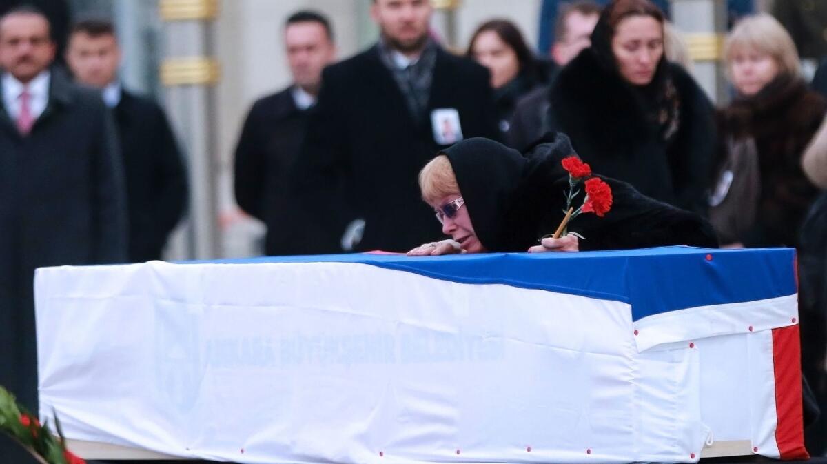 Marina Davydova Karlova, widow of Russian Ambassador to Turkey Andrei Karlov, weeps over his coffin during a ceremonial farewell on the tarmac of Ankara's Esenboga Airport on Dec. 20, 2016.