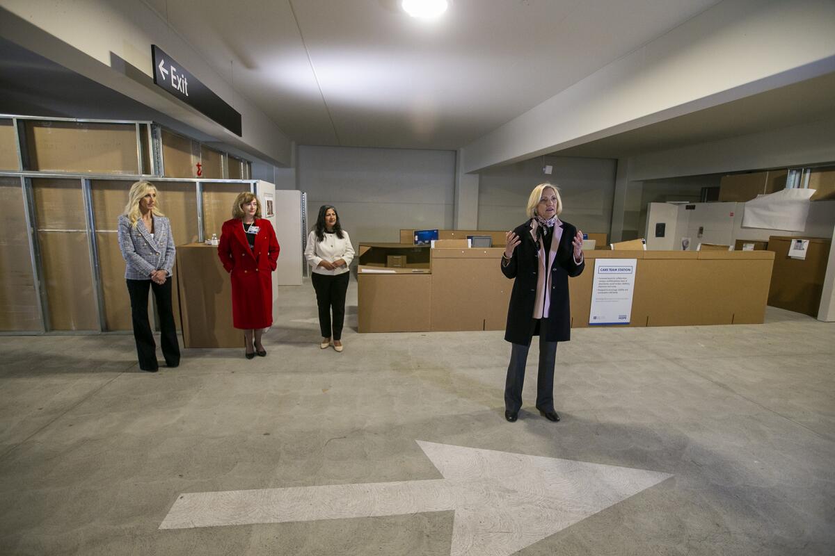 Annette Walker, right, president of City of Hope Orange County, speaks during a tour of a replica of its new hospital.
