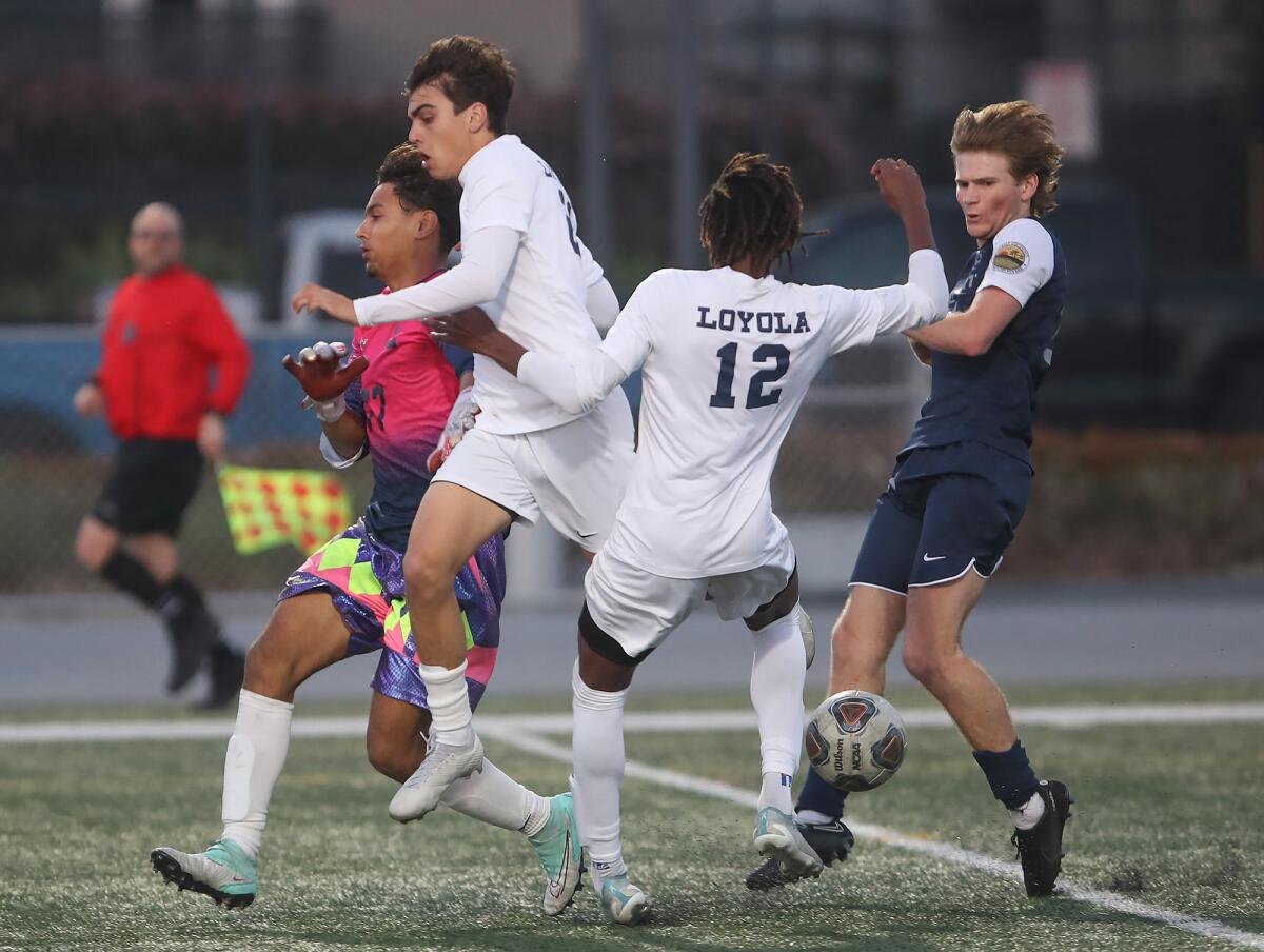 Newport Harbor's Beck Brosnan, far right, dribbles into the open field past Loyola's Peter Borges (12) on Friday.
