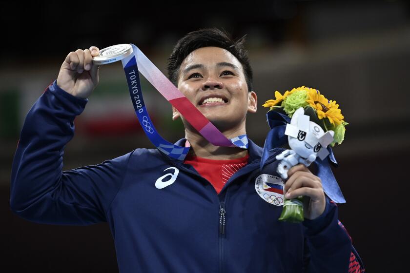The Philippines Nesthy Petecio her silver medal after losing to Japan's Sena Irie in the women's featherweight 60-kg final boxing match at the 2020 Summer Olympics, Tuesday, Aug. 3, 2021, in Tokyo, Japan. (AP Photo/Luis ROBAYO, Pool)