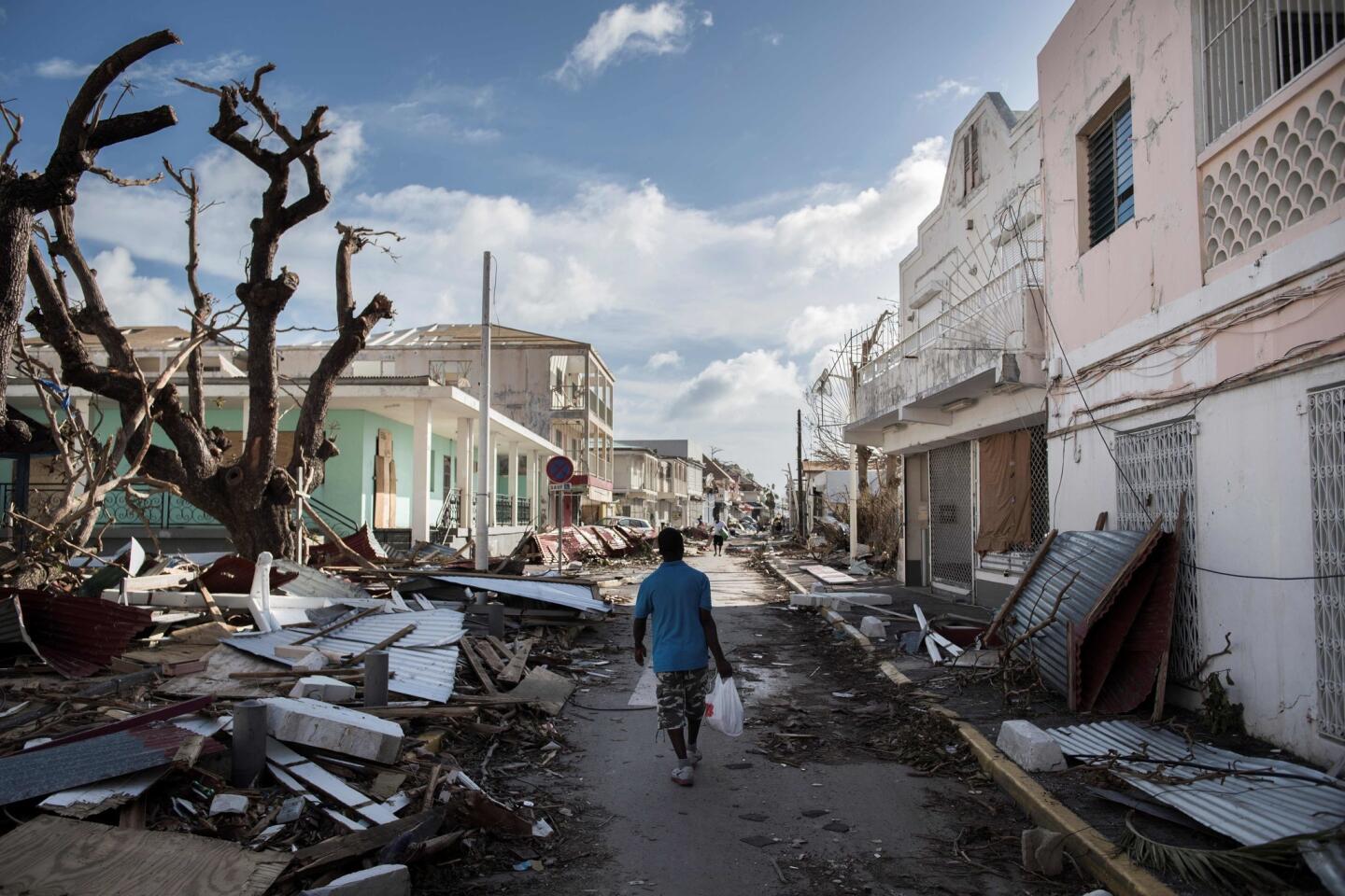A man walks on a street covered in debris left behind by Hurricane Irma on the French island of Saint Martin, near Marigot, on Sept. 8, 2017.