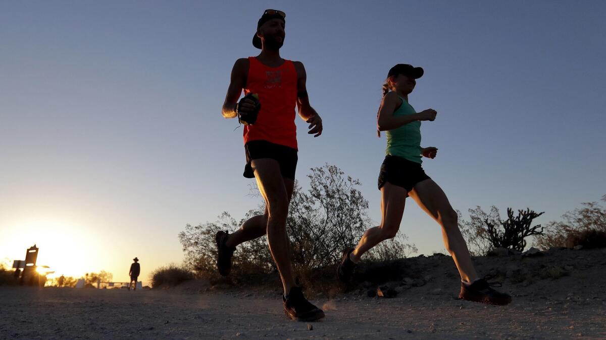 A pair of runners in Phoenix hit the trails before sunrise to avoid excessive heat. New research shows that places that are drier have also been getting hotter in the U.S.