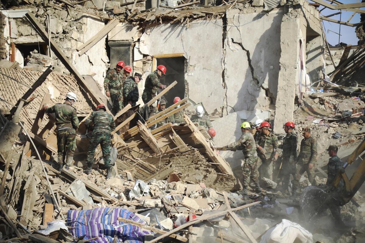 Rescuers in Ganja, Azerbaijan, after alleged shelling by Armenian artillery