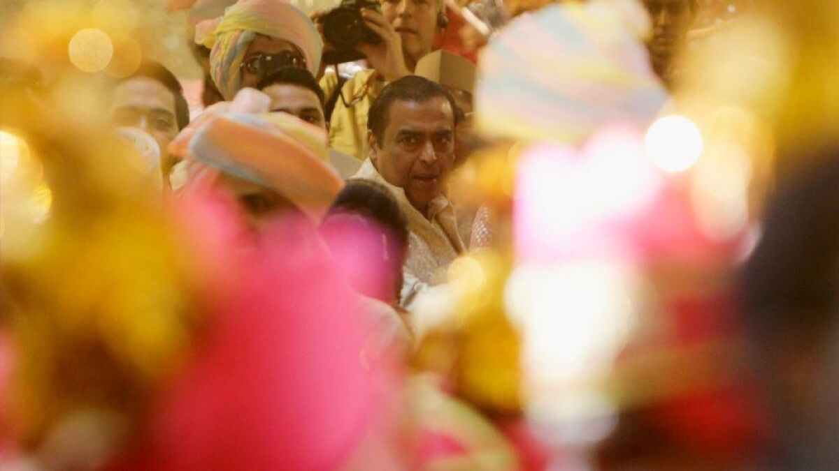 Mukesh Ambani, among the world's 20 richest people, awaits the arrival of his daughter's groom, Anand Piramal, at a ceremony Wednesday in Mumbai.
