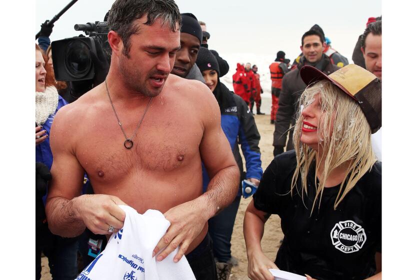 Actor Taylor Kinney and fiancee Lady Gaga were among those dipping into freezing Lake Michigan on Sunday in Chicago. The 15th annual Polar Plunge raised money for the local chapter of Special Olympics.