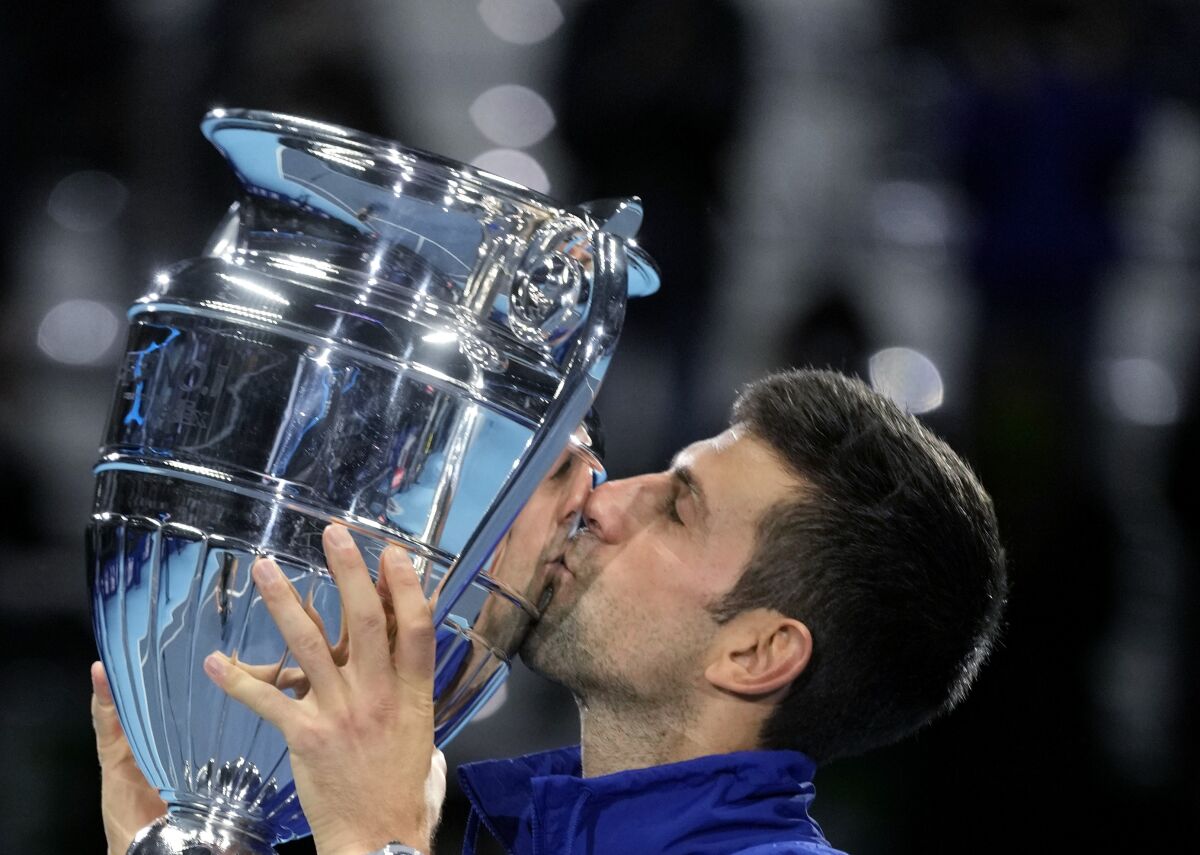 Serbia's Novak Djokovic kisses the trophy as ATP world best player, at the Tennis ATP World Tour Finals, at the Pala Alpitour in Turin, Monday, Nov. 15, 2021. (AP Photo/Luca Bruno)